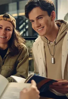 A teenage boy wears a Plaud NotePin with a lanyard